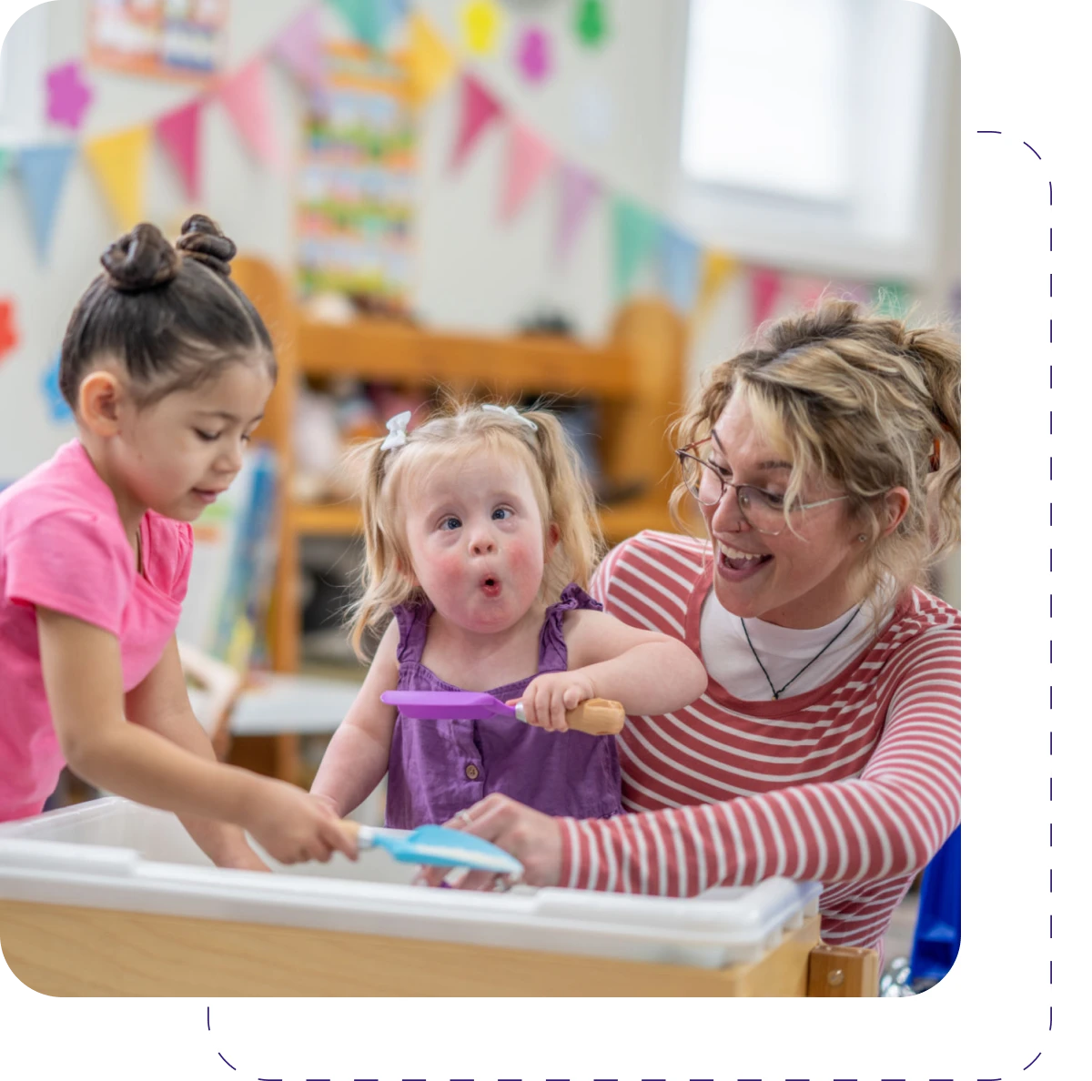 Children playing with teacher in classroom.